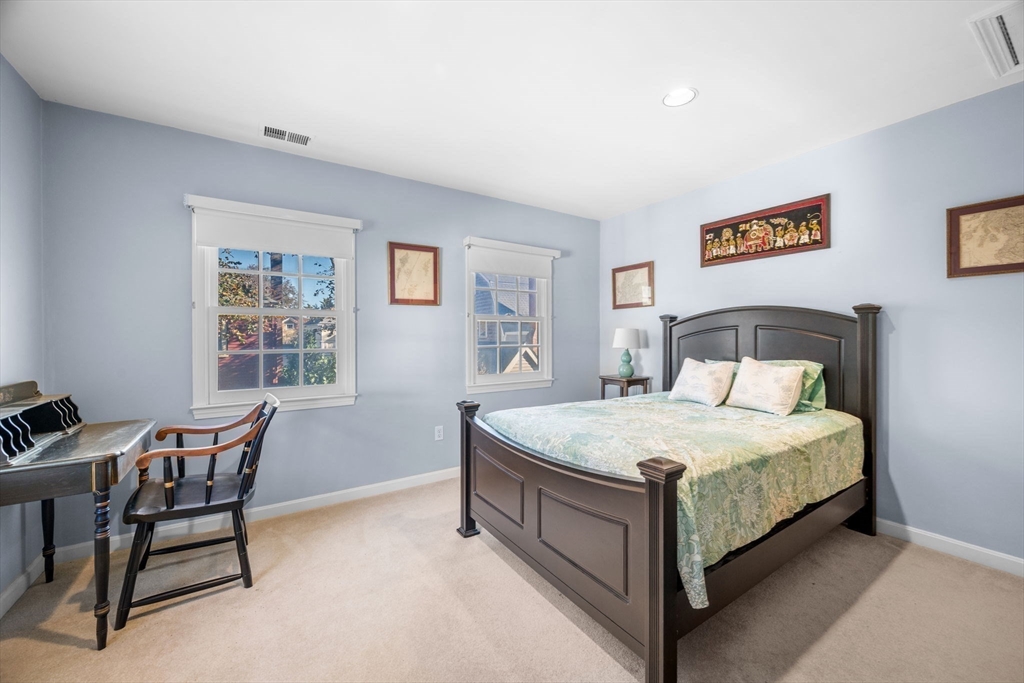 33 Pleasant Street, Unit 33 Manchester, MA 01944 - Photo 28 of 40 a spacious bedroom with a bed and a desk