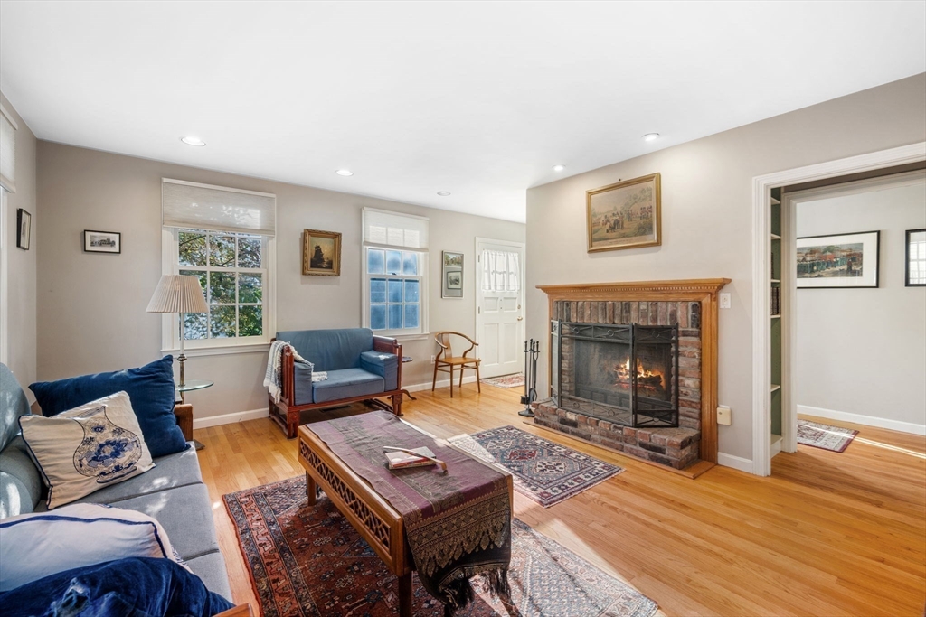 33 Pleasant Street, Unit 33 Manchester, MA 01944 - Photo 3 of 40 a living room with furniture a window and a fireplace