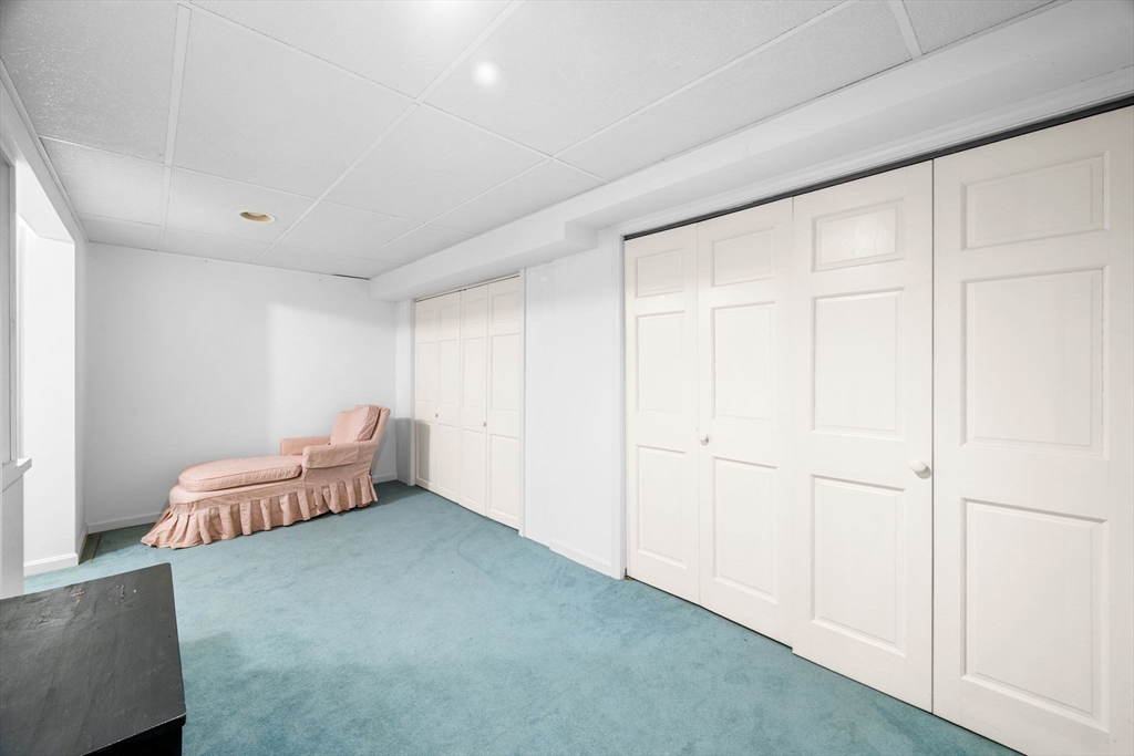 33 Pleasant Street, Unit 33 Manchester, MA 01944 - Photo 33 of 40 a living room with furniture and a wooden floor