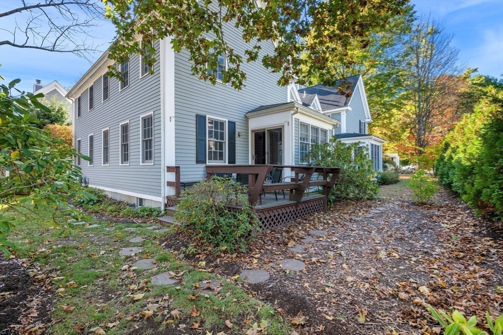 33 Pleasant Street, Unit 33 Manchester, MA 01944 - Photo 38 of 40 a view of a house with a yard and potted plants