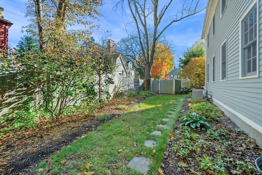 33 Pleasant Street, Unit 33 Manchester, MA 01944 - Photo 39 of 40 a backyard of a house with lots of green space