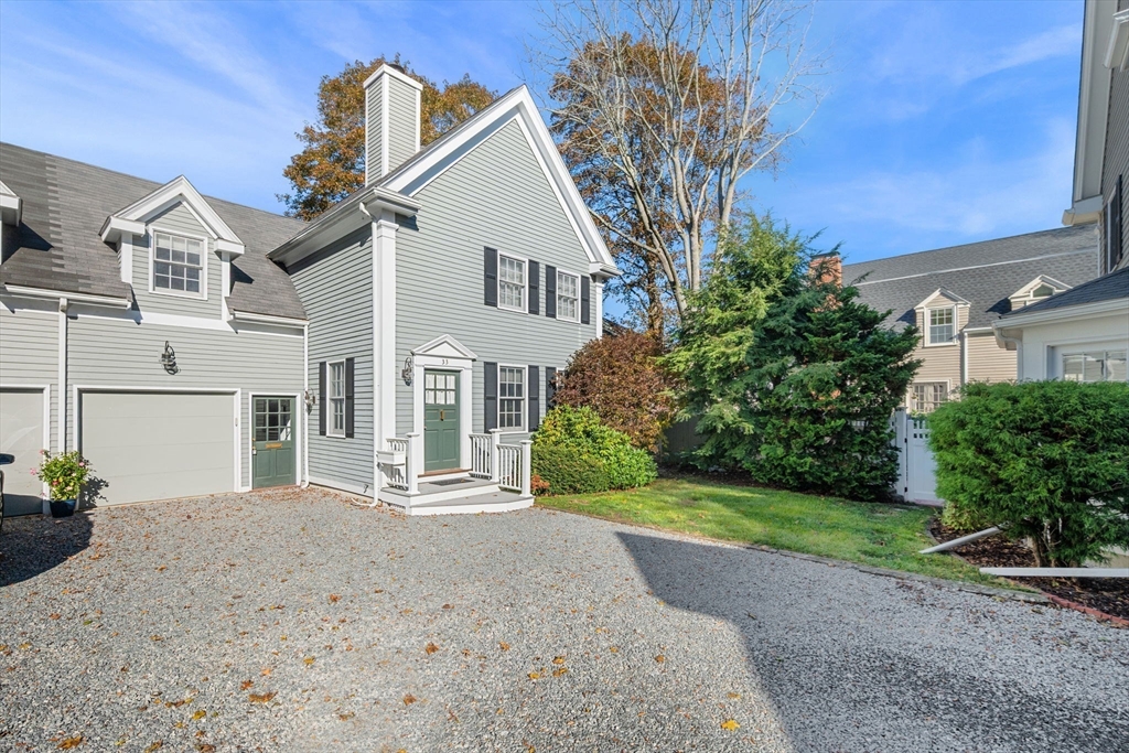33 Pleasant Street, Unit 33 Manchester, MA 01944 - Photo 40 of 40 a front view of a house with a yard and garage