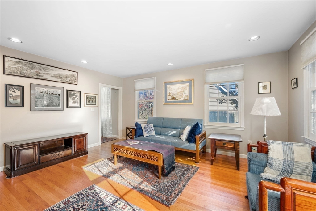 33 Pleasant Street, Unit 33 Manchester, MA 01944 - Photo 10 of 40 a living room with furniture a rug and a fireplace