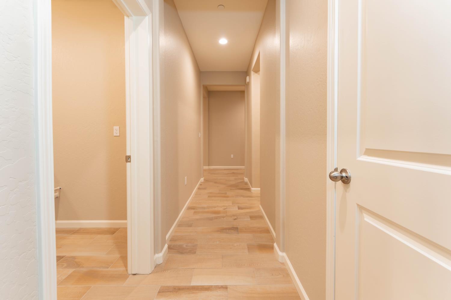 30480 Bellwood Road Visalia, CA 93291 - Photo 14 of 37 a view of a hallway with wooden floor