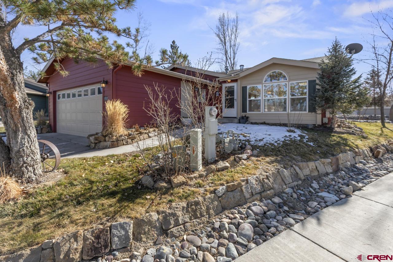 901 6530 Road, Unit 1312 Montrose, CO 81401 - Photo 1 of 30 a front view of a house with garden