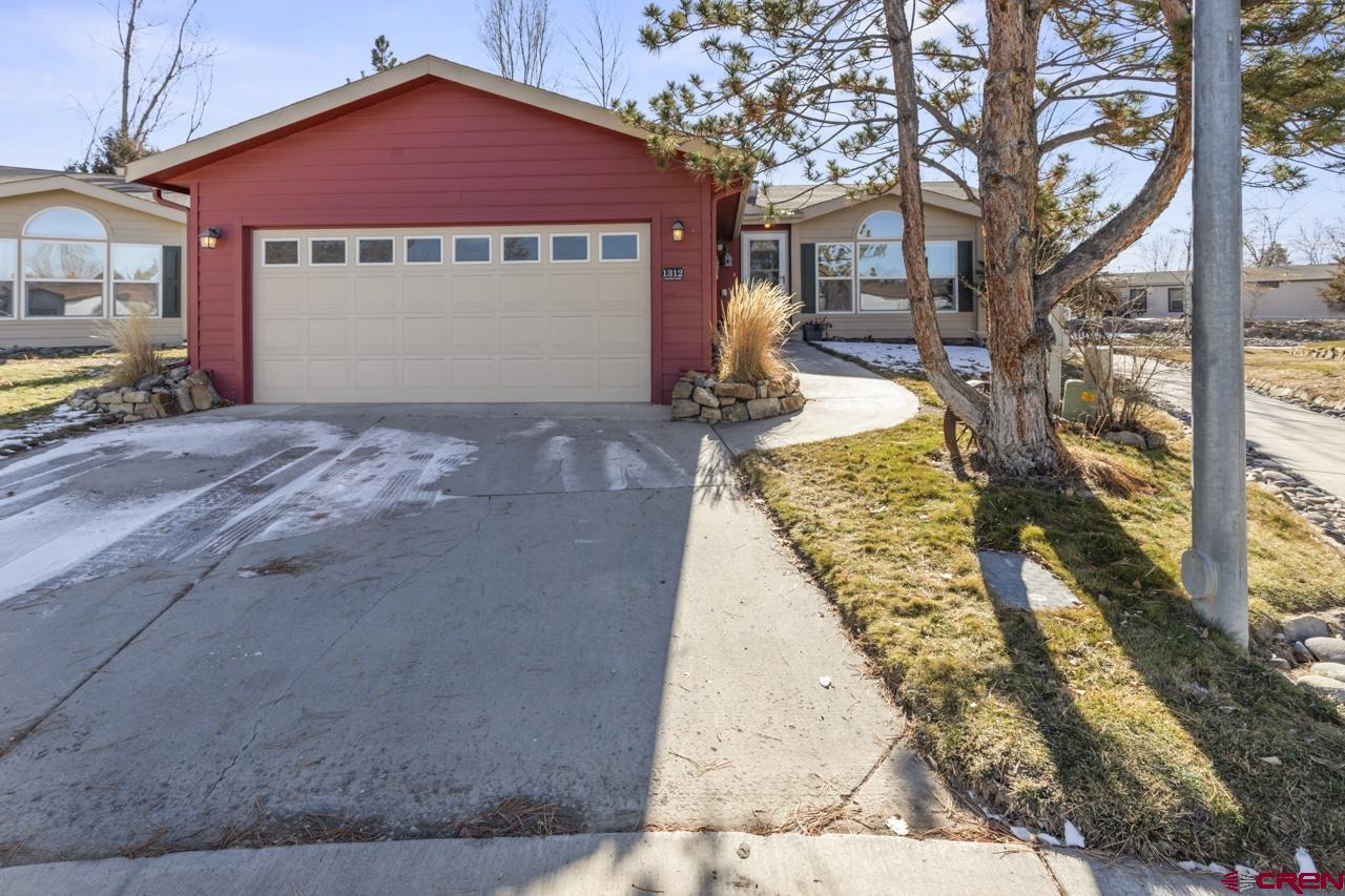 901 6530 Road, Unit 1312 Montrose, CO 81401 - Photo 14 of 30 a front view of a house with a yard