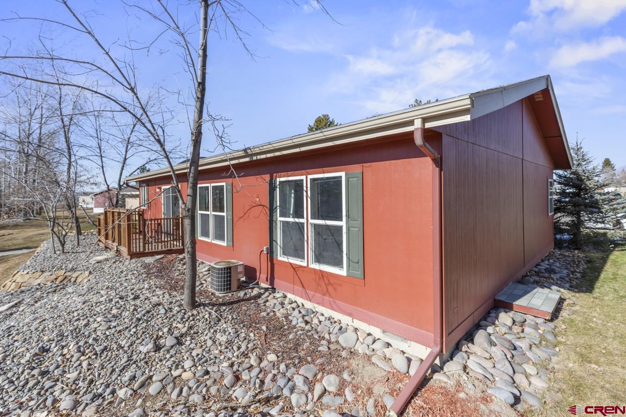 901 6530 Road, Unit 1312 Montrose, CO 81401 - Photo 16 of 30 a front view of a house with a yard