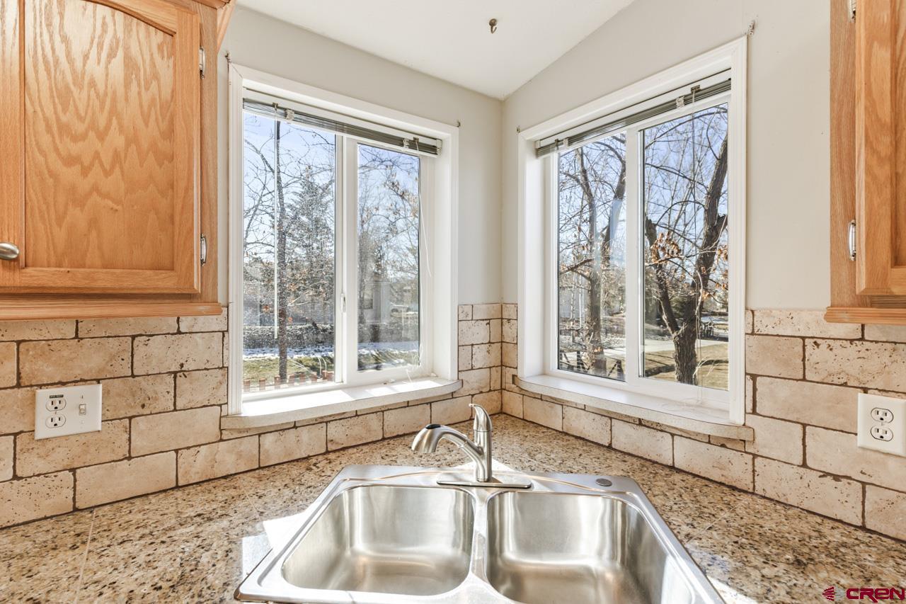 901 6530 Road, Unit 1312 Montrose, CO 81401 - Photo 2 of 30 a kitchen with a sink and large window