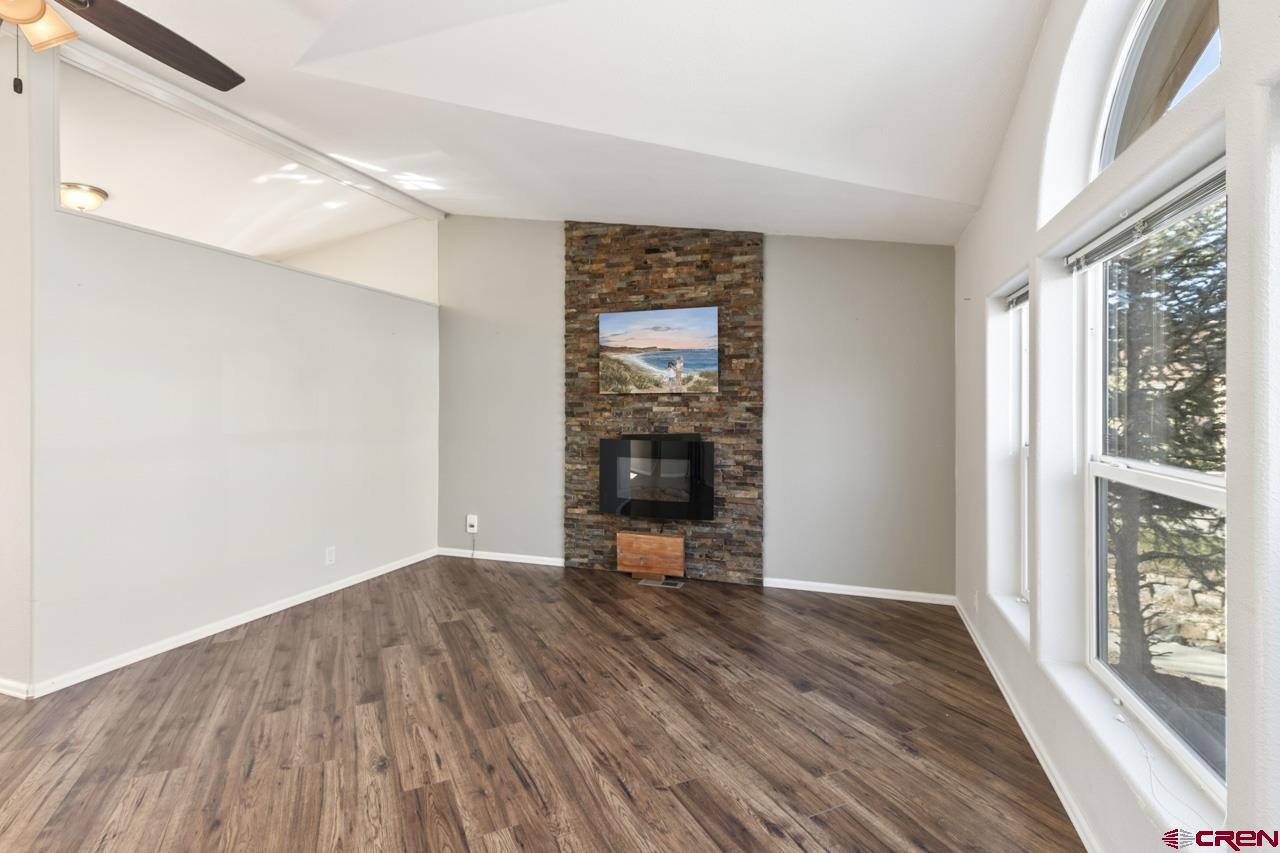 901 6530 Road, Unit 1312 Montrose, CO 81401 - Photo 5 of 30 a view of a livingroom with wooden floor and a fireplace