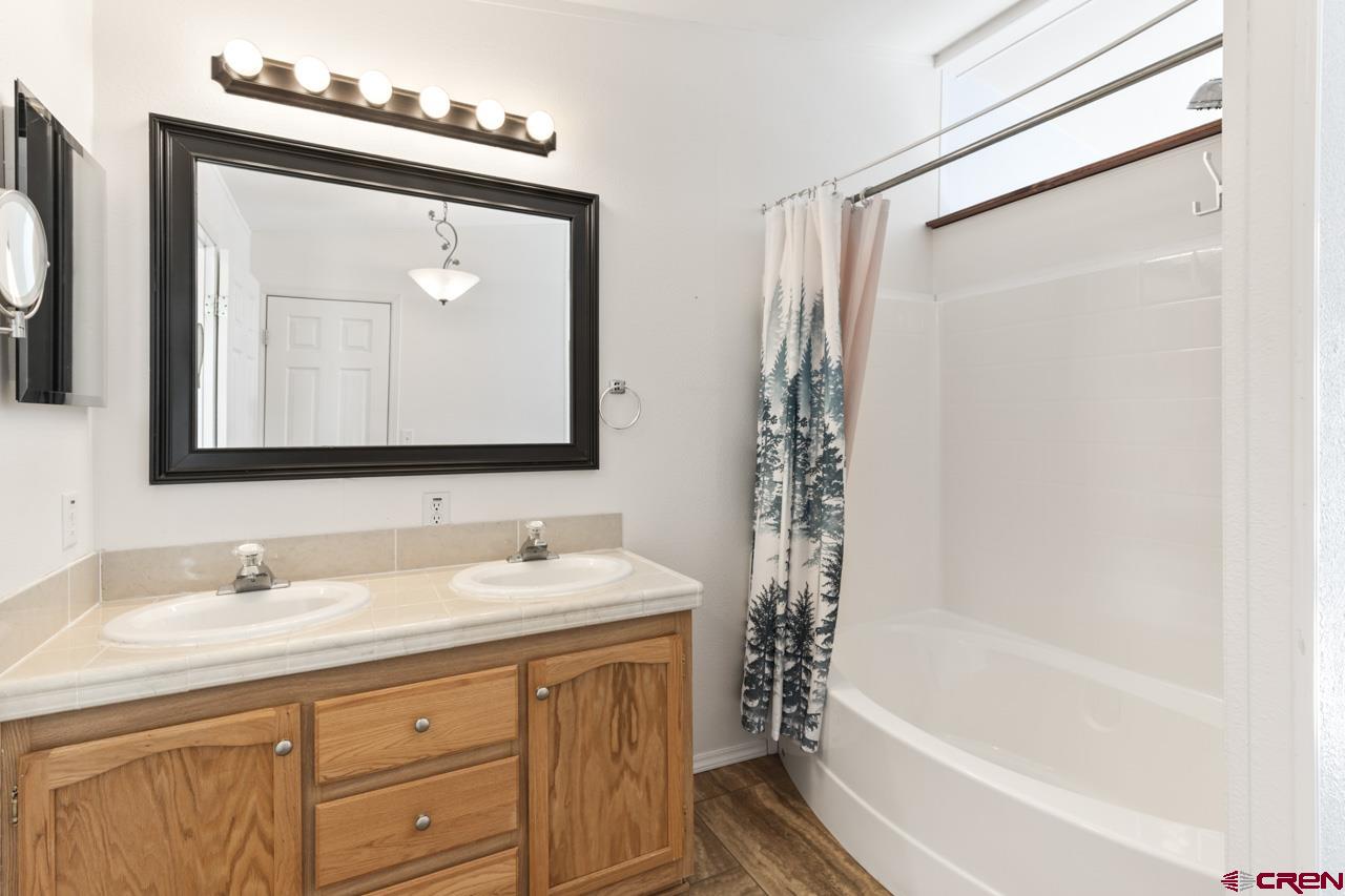 901 6530 Road, Unit 1312 Montrose, CO 81401 - Photo 9 of 30 a bathroom with a tub sink and mirror