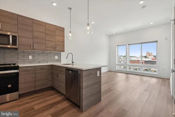 a kitchen with kitchen island granite countertop wooden cabinets and white appliances