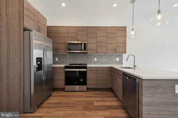 a kitchen with stainless steel appliances granite countertop a refrigerator and a sink