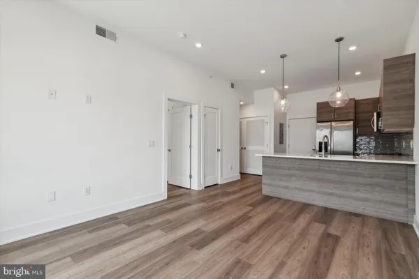 a view of room with window and wooden floor