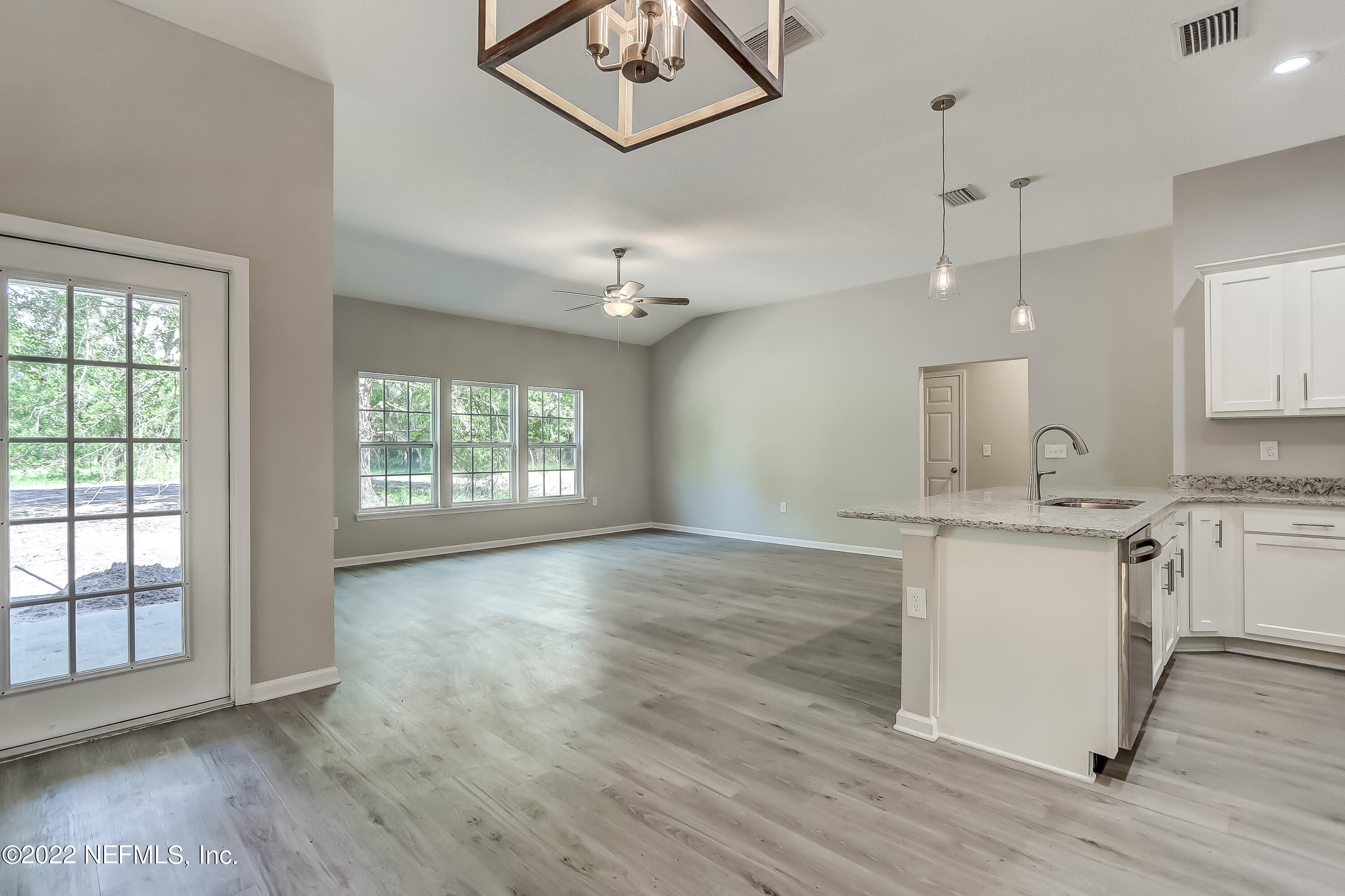1187 Hatcher Road Middleburg, FL 32068 - Photo 11 of 42 a view of a kitchen with a sink cabinets and wooden floor