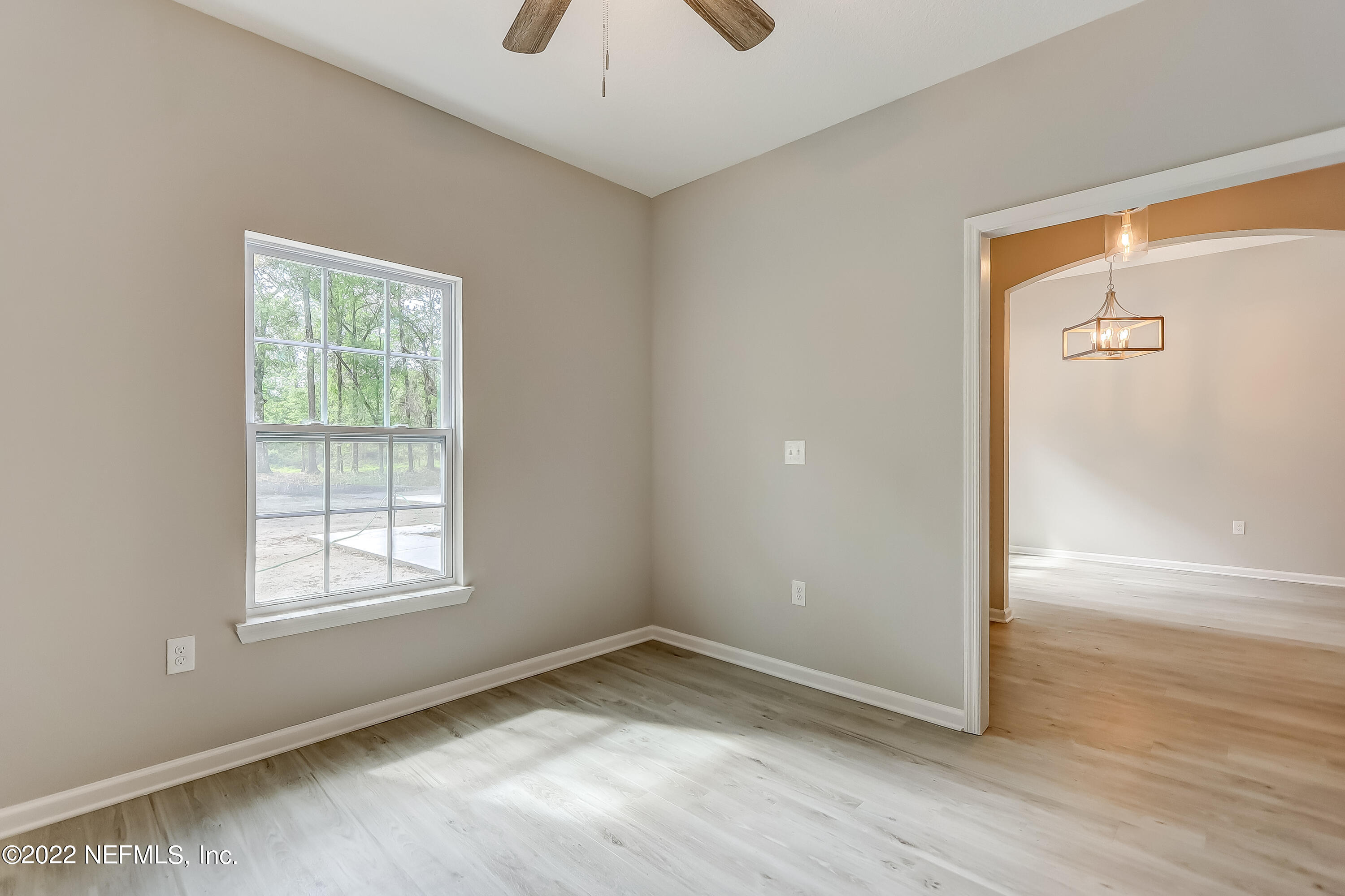 1187 Hatcher Road Middleburg, FL 32068 - Photo 13 of 42 a view of an empty room with wooden floor and a window