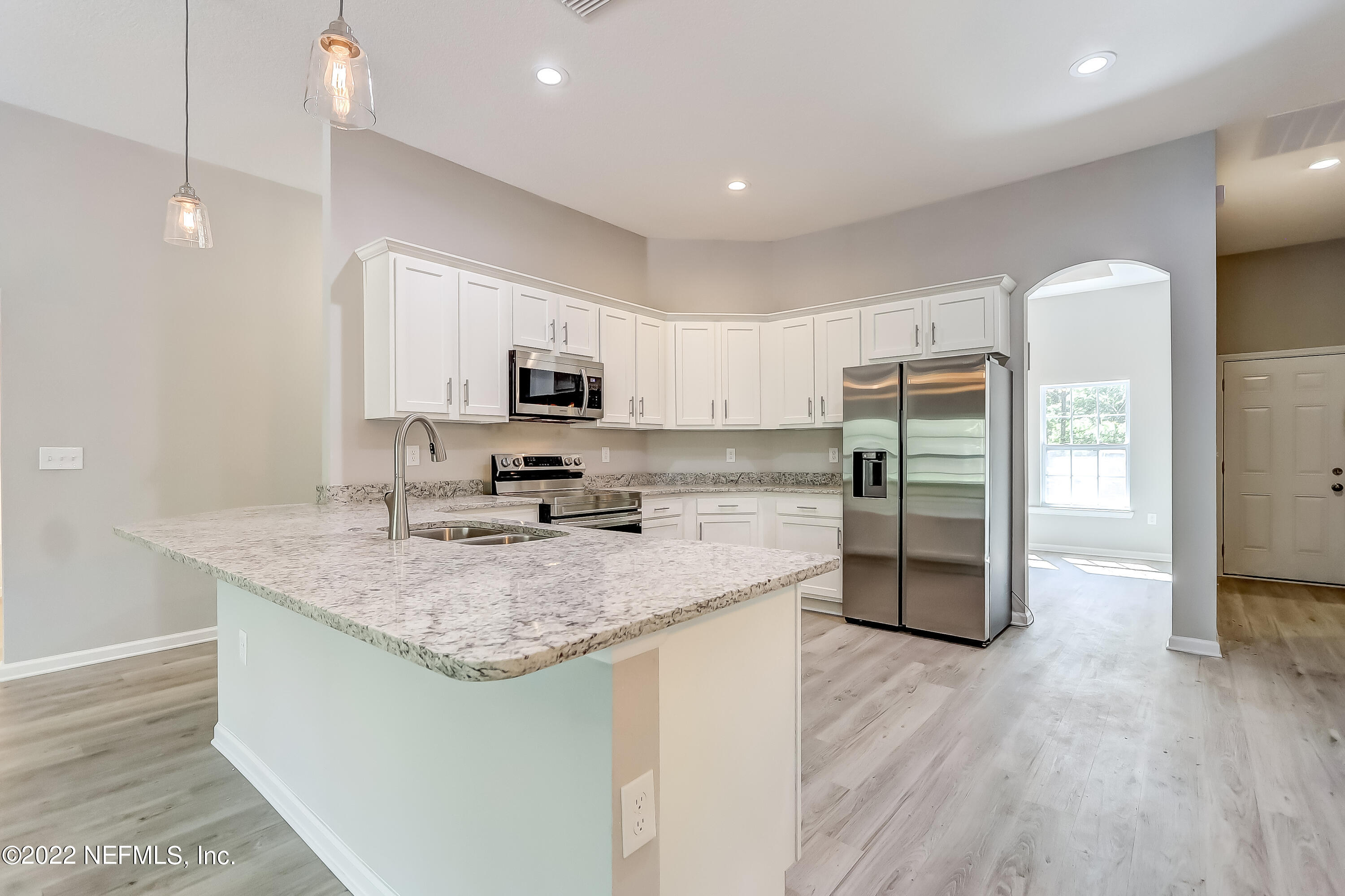 1187 Hatcher Road Middleburg, FL 32068 - Photo 17 of 42 a kitchen with stainless steel appliances granite countertop a sink refrigerator and microwave