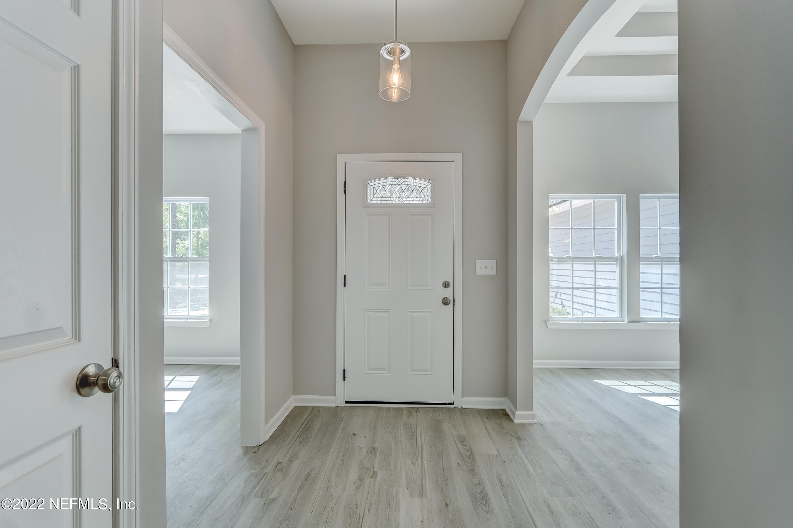1187 Hatcher Road Middleburg, FL 32068 - Photo 2 of 42 an empty room with wooden floor and a window