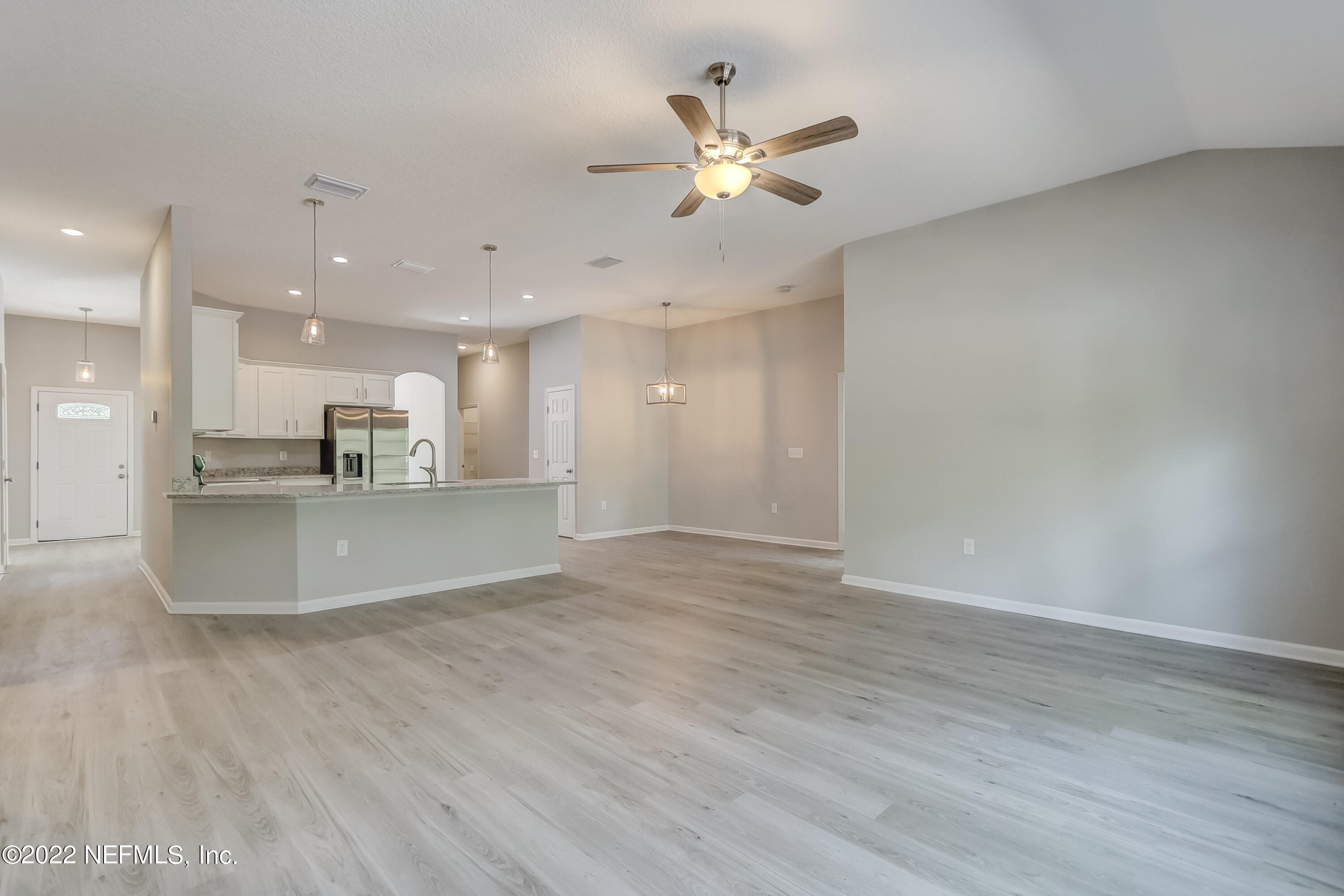 1187 Hatcher Road Middleburg, FL 32068 - Photo 24 of 42 a view of an empty room and kitchen view of wooden floor