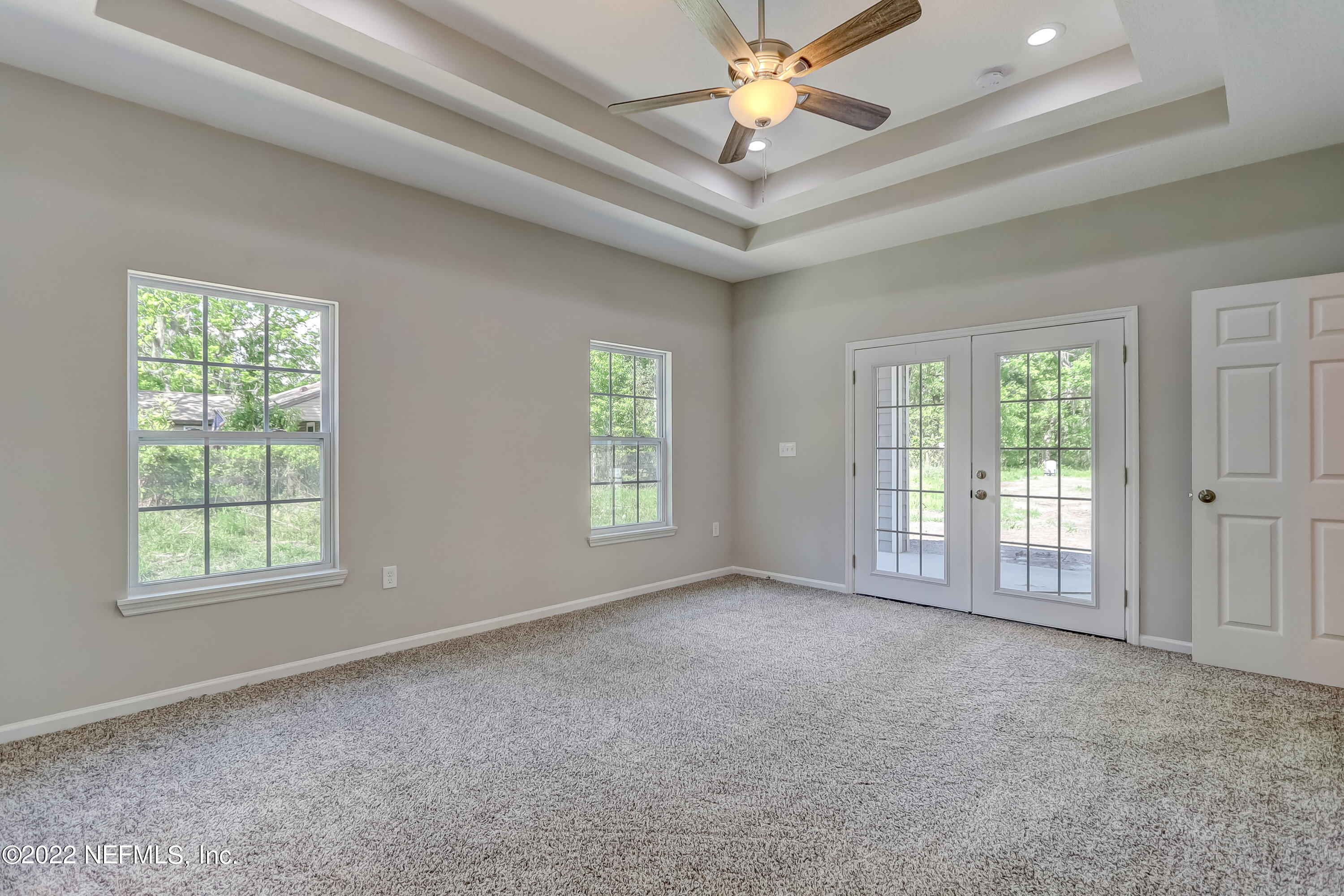 1187 Hatcher Road Middleburg, FL 32068 - Photo 29 of 42 an empty room with windows and fan