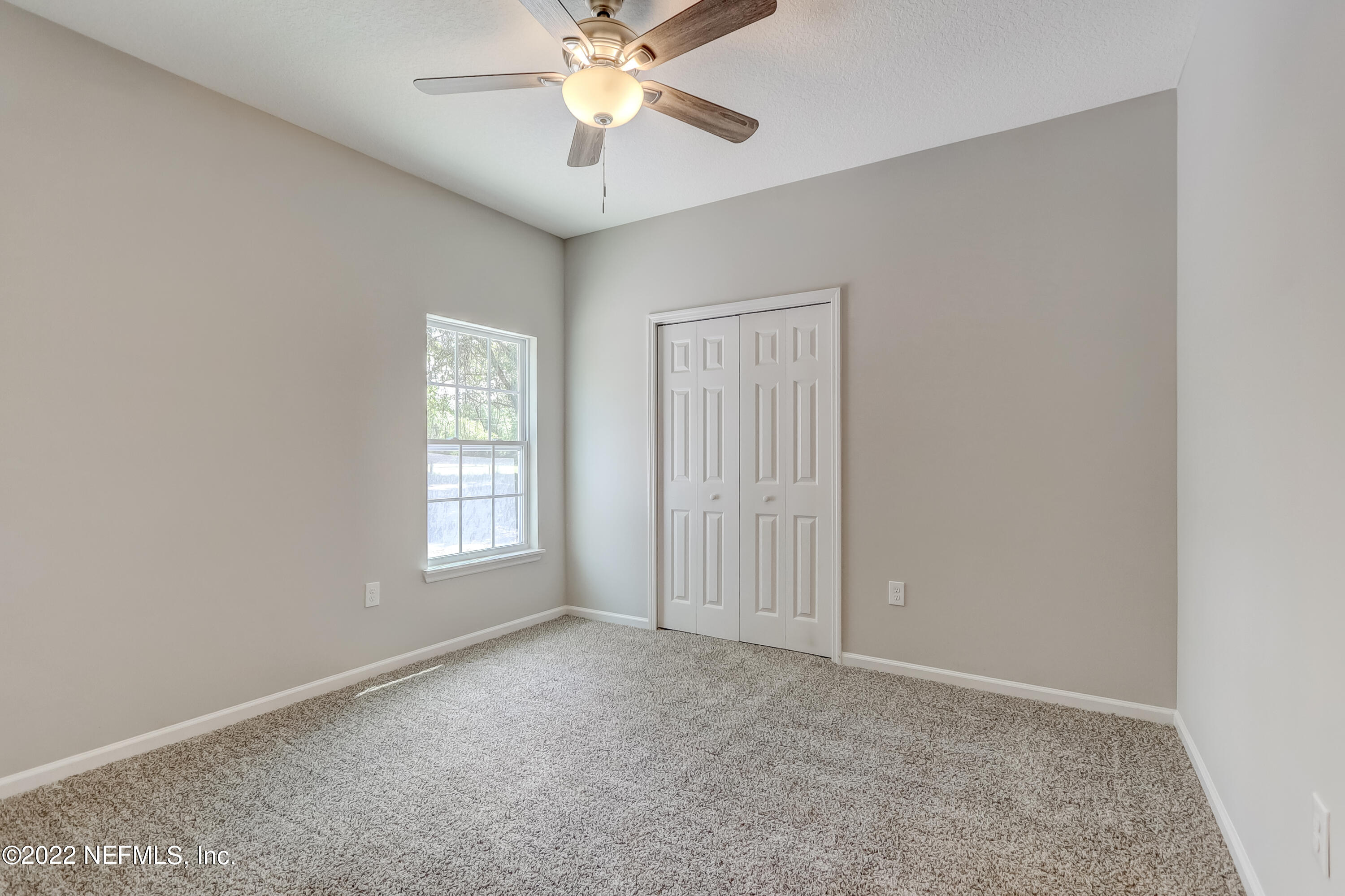 1187 Hatcher Road Middleburg, FL 32068 - Photo 36 of 42 an empty room with windows and fan