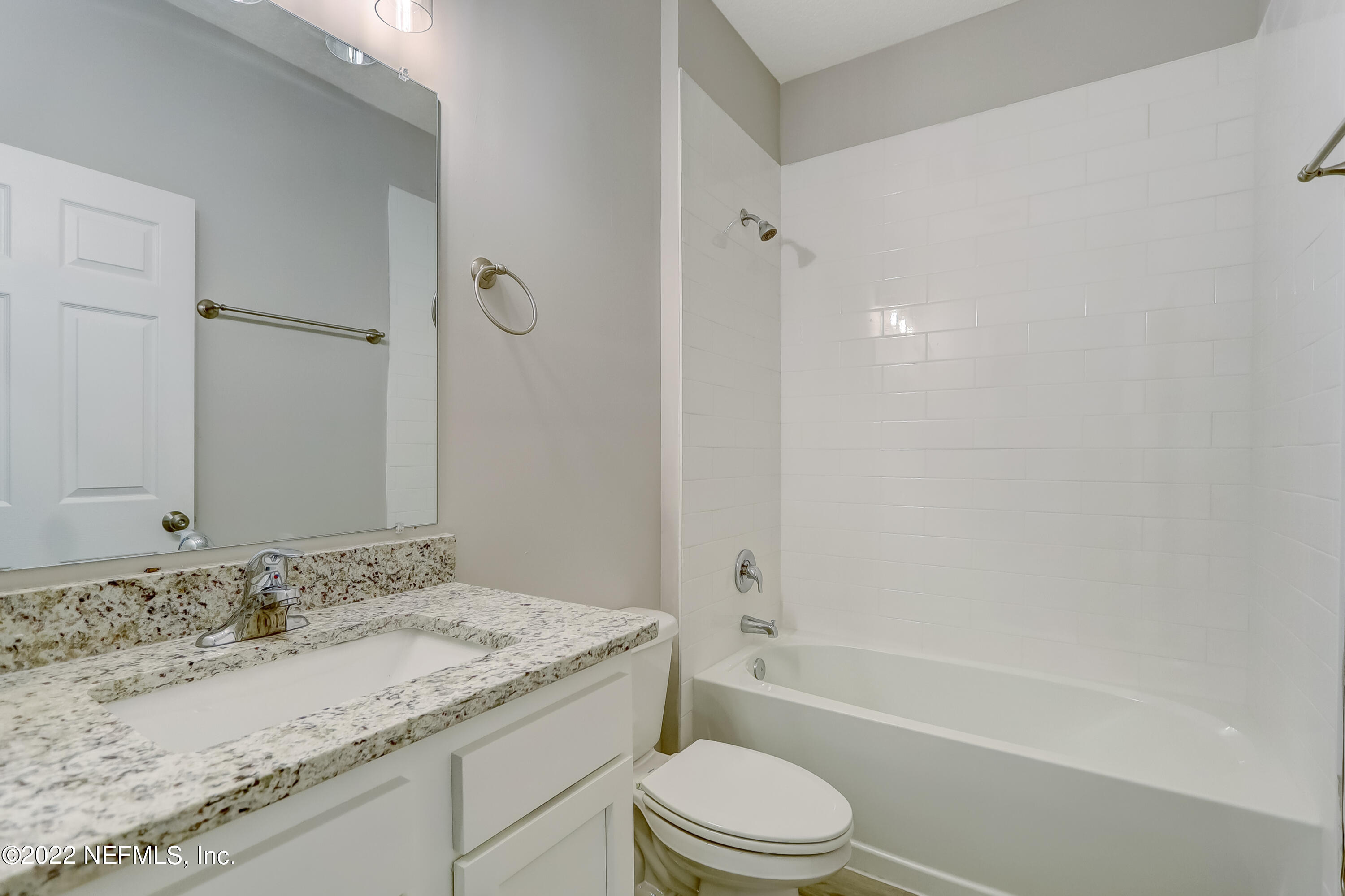 1187 Hatcher Road Middleburg, FL 32068 - Photo 38 of 42 a bathroom with a granite countertop sink a toilet and shower