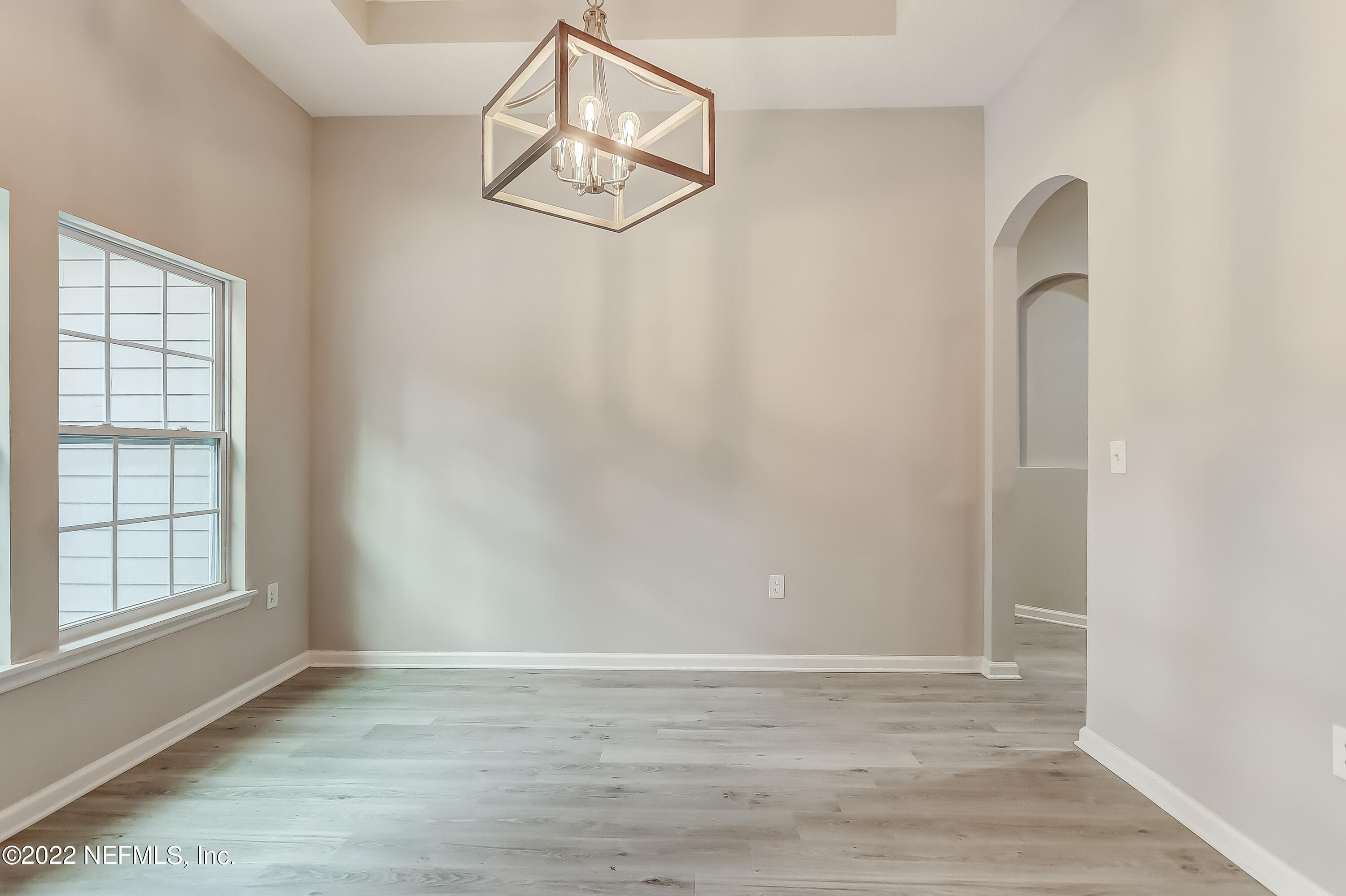 1187 Hatcher Road Middleburg, FL 32068 - Photo 5 of 42 an empty room with wooden floor and windows