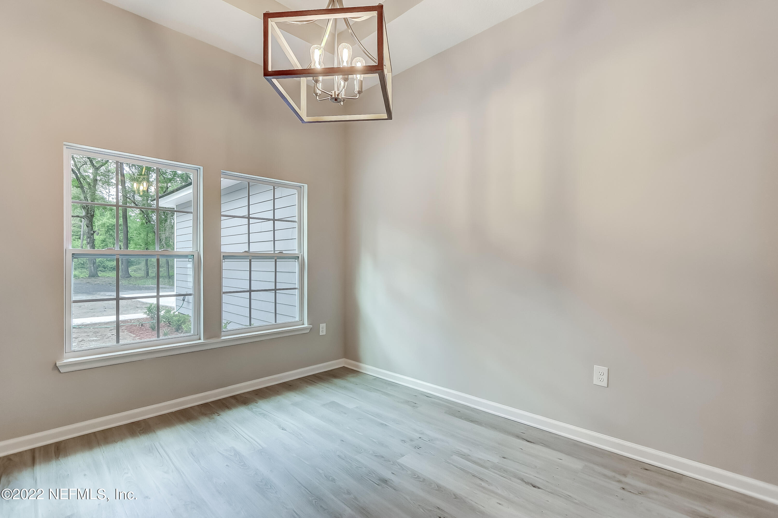 1187 Hatcher Road Middleburg, FL 32068 - Photo 6 of 42 an empty room with wooden floor and windows