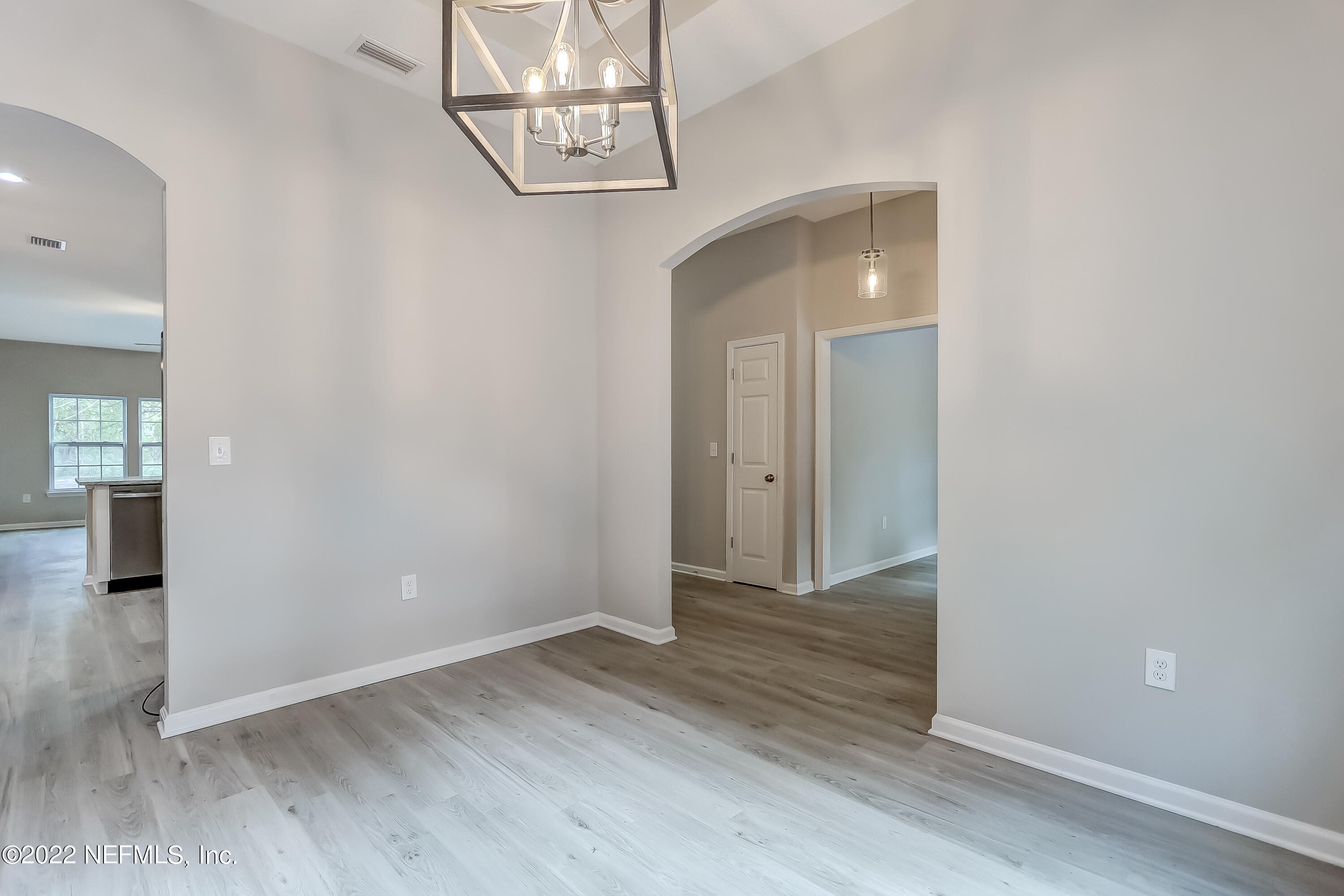 1187 Hatcher Road Middleburg, FL 32068 - Photo 8 of 42 an empty room with wooden floor and windows