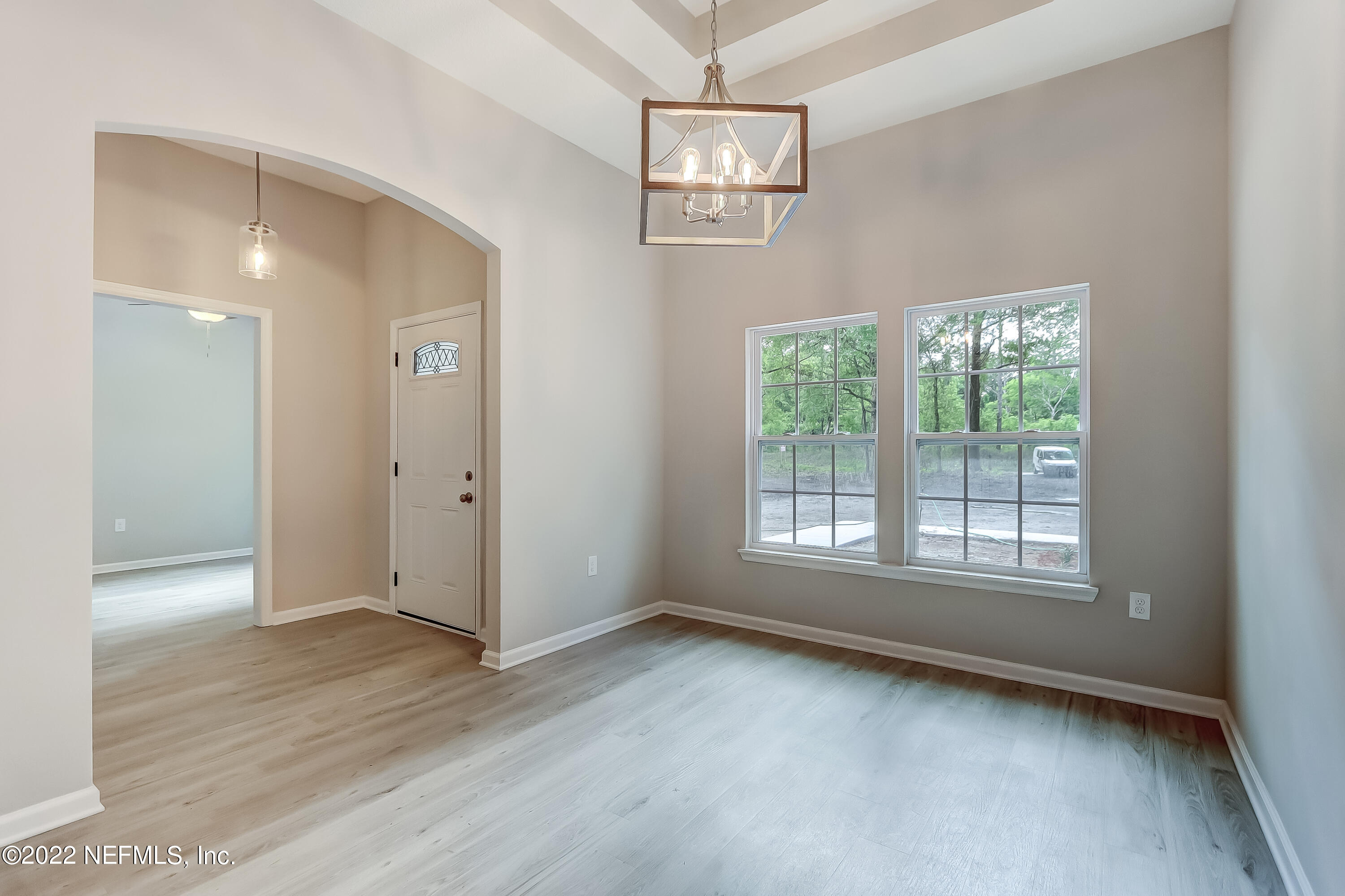1187 Hatcher Road Middleburg, FL 32068 - Photo 9 of 42 a view of an empty room with wooden floor and a window