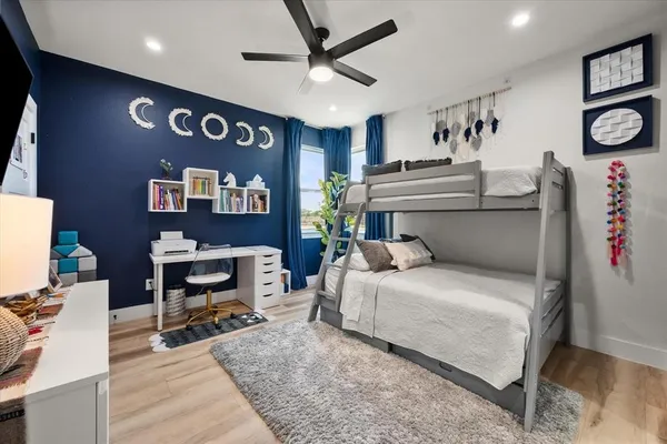 a bedroom with a large bed and a chandelier