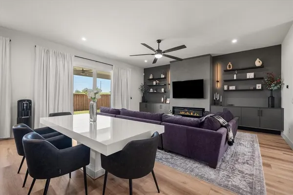 a living room with furniture a rug and a flat screen tv