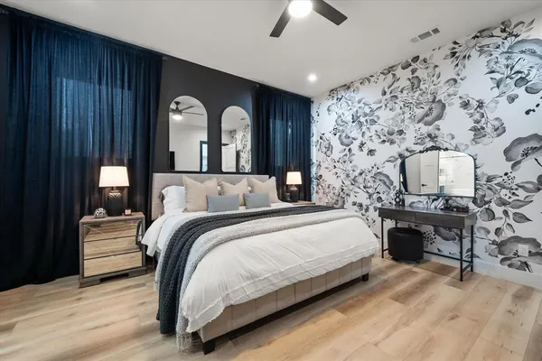 a bedroom with bed and wooden floor