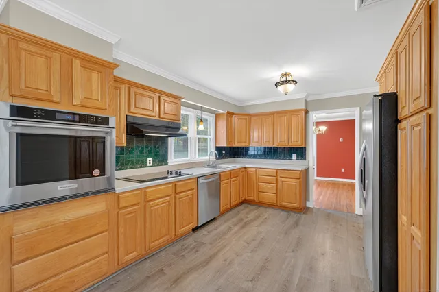 a kitchen with granite countertop white cabinets and white appliances