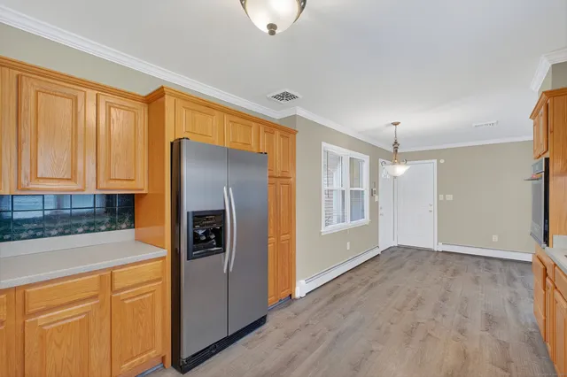 a kitchen with stainless steel appliances granite countertop a refrigerator and a sink