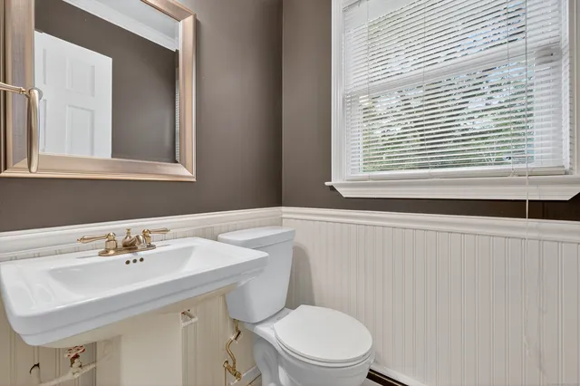 a bathroom with a sink a mirror and a toilet