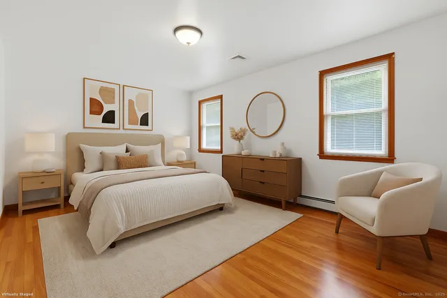 a spacious bedroom with a bed a couch and dresser