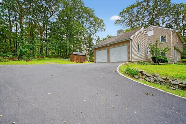 a view of a house with a yard and garage