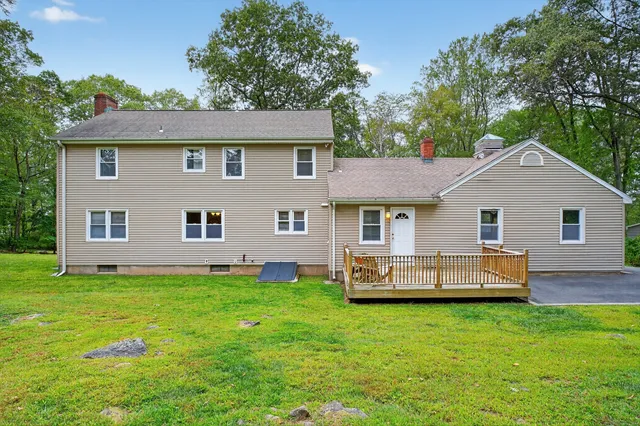 a front view of a house with a garden and yard