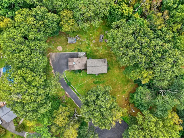 an aerial view of a house with a yard