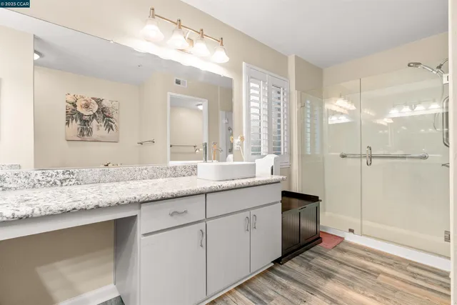 a bathroom with a granite countertop sink mirror and double