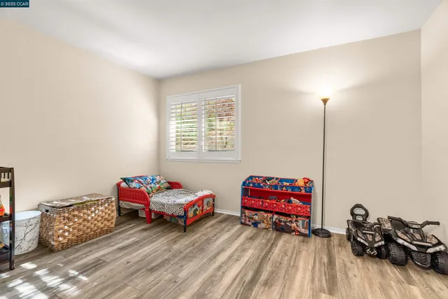 a living room with furniture window and a wooden floor
