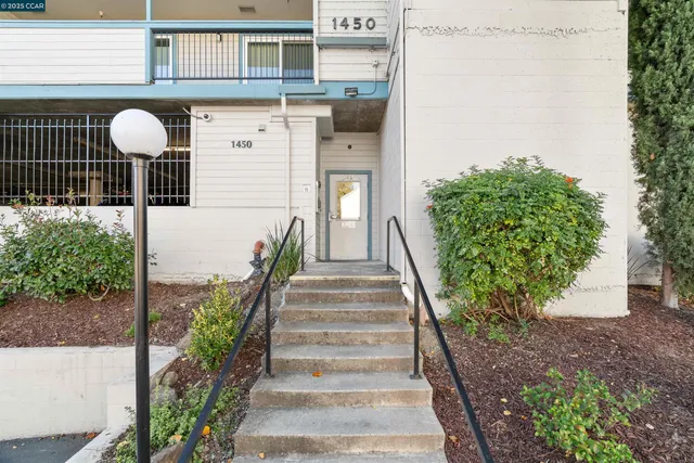 a view of a brick house with potted plants