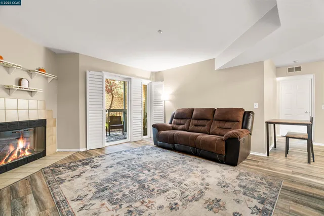 a living room with furniture a window and a fireplace