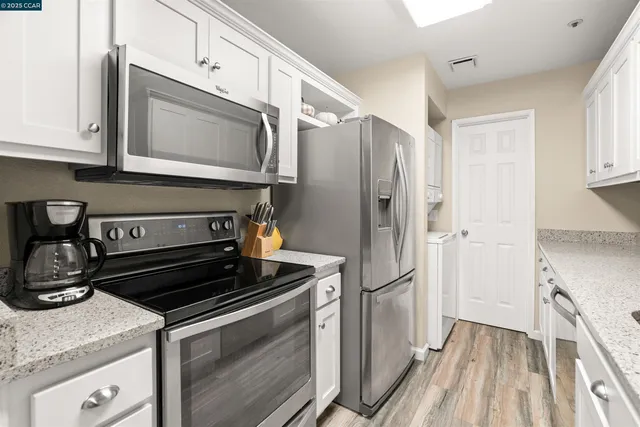 a kitchen with a refrigerator stove and microwave