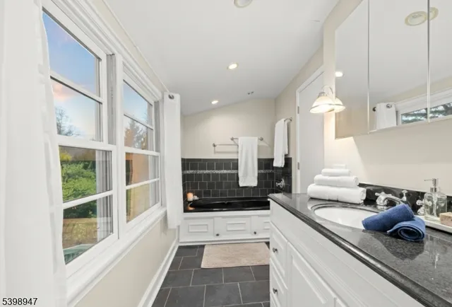 a large white kitchen with a large window