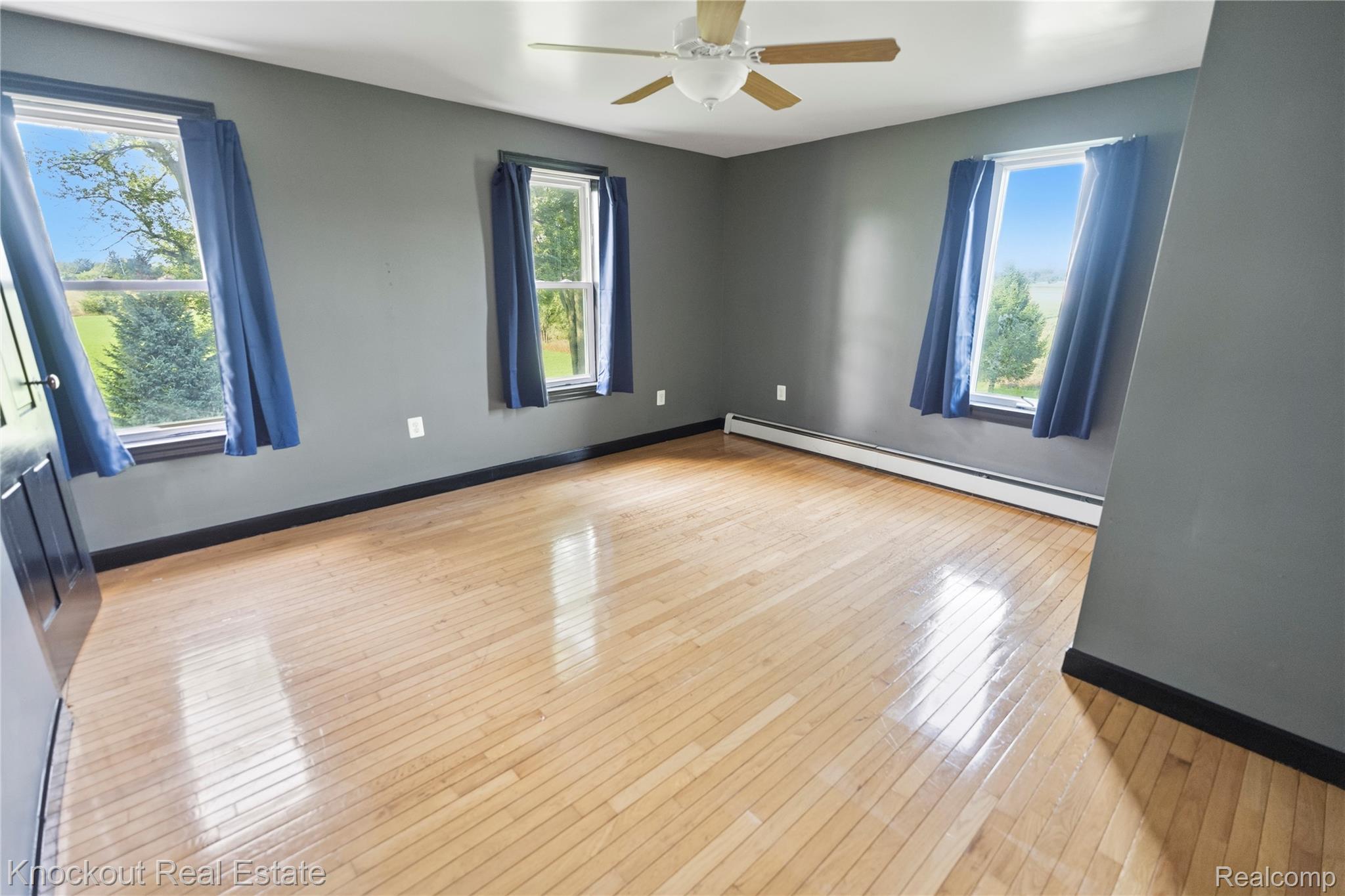 5750 Maple Road Frankenmuth, MI 48734 - Photo 24 of 60 Hardwood flooring, multiple windows, ceiling fan, and baseboard heating