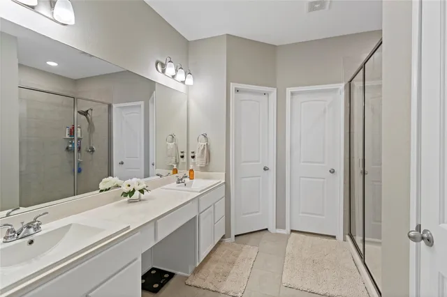 a bathroom with a shower and a glass door