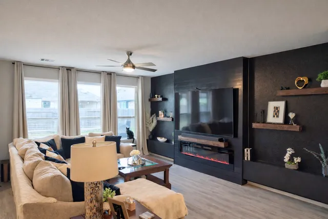 a living room with furniture and a flat screen tv