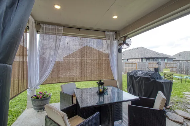 a view of a house with backyard sitting area and garden