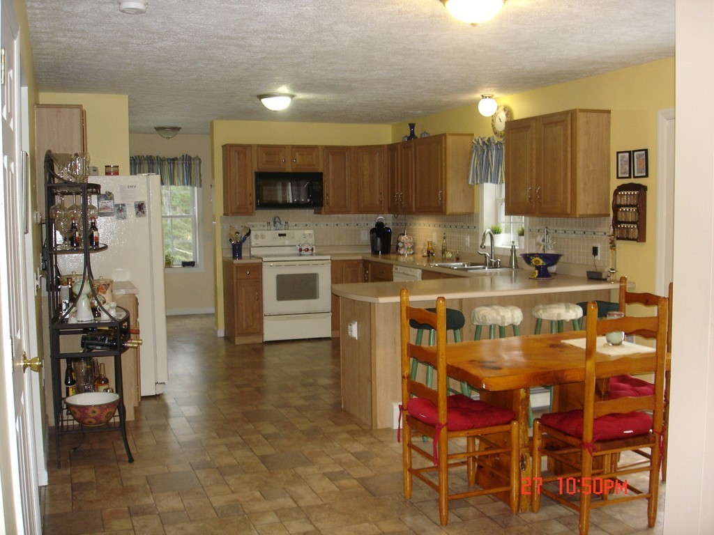 30 Bluefield Road Ashburnham, MA 01430 - Photo 7 of 30 a kitchen with stainless steel appliances granite countertop a sink and cabinets